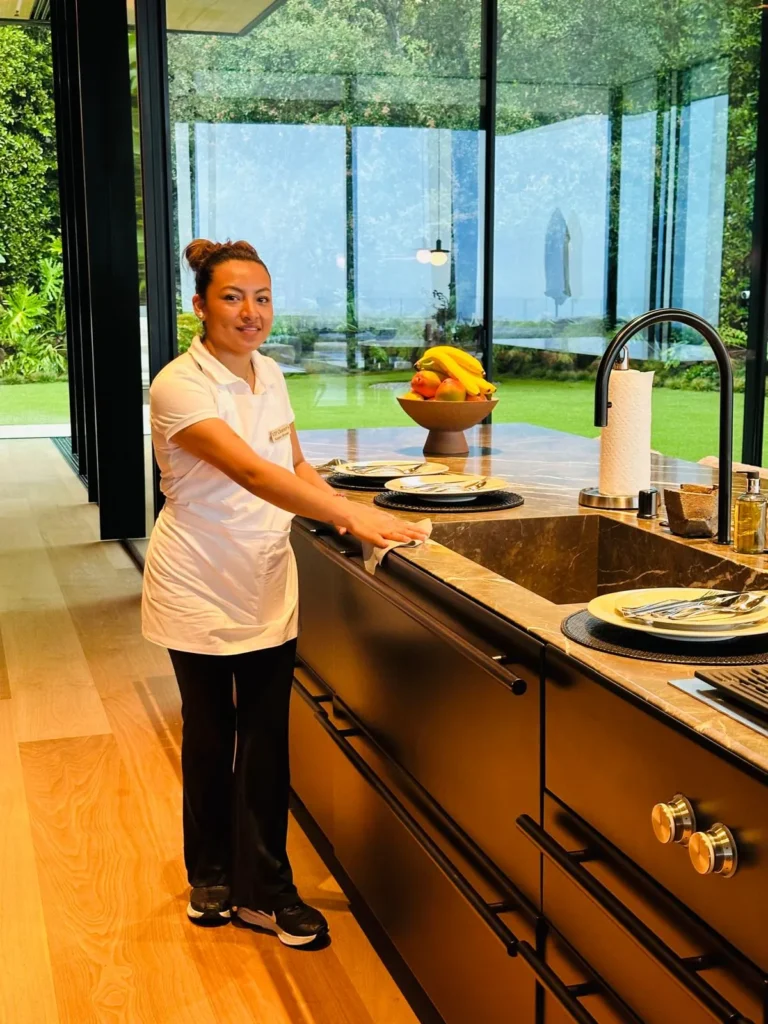 FJ Luxury Services housekeeper cleaning a luxury kitchen in Los Angeles